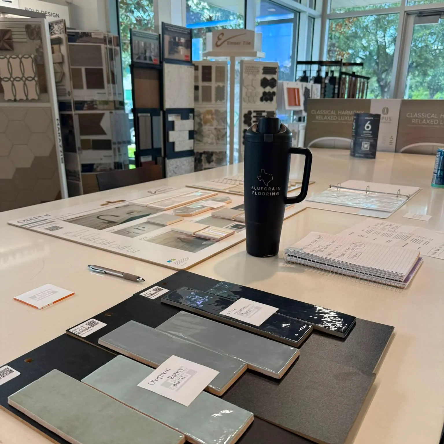 Material samples laid out on the table at the Bluegrain Flooring design center