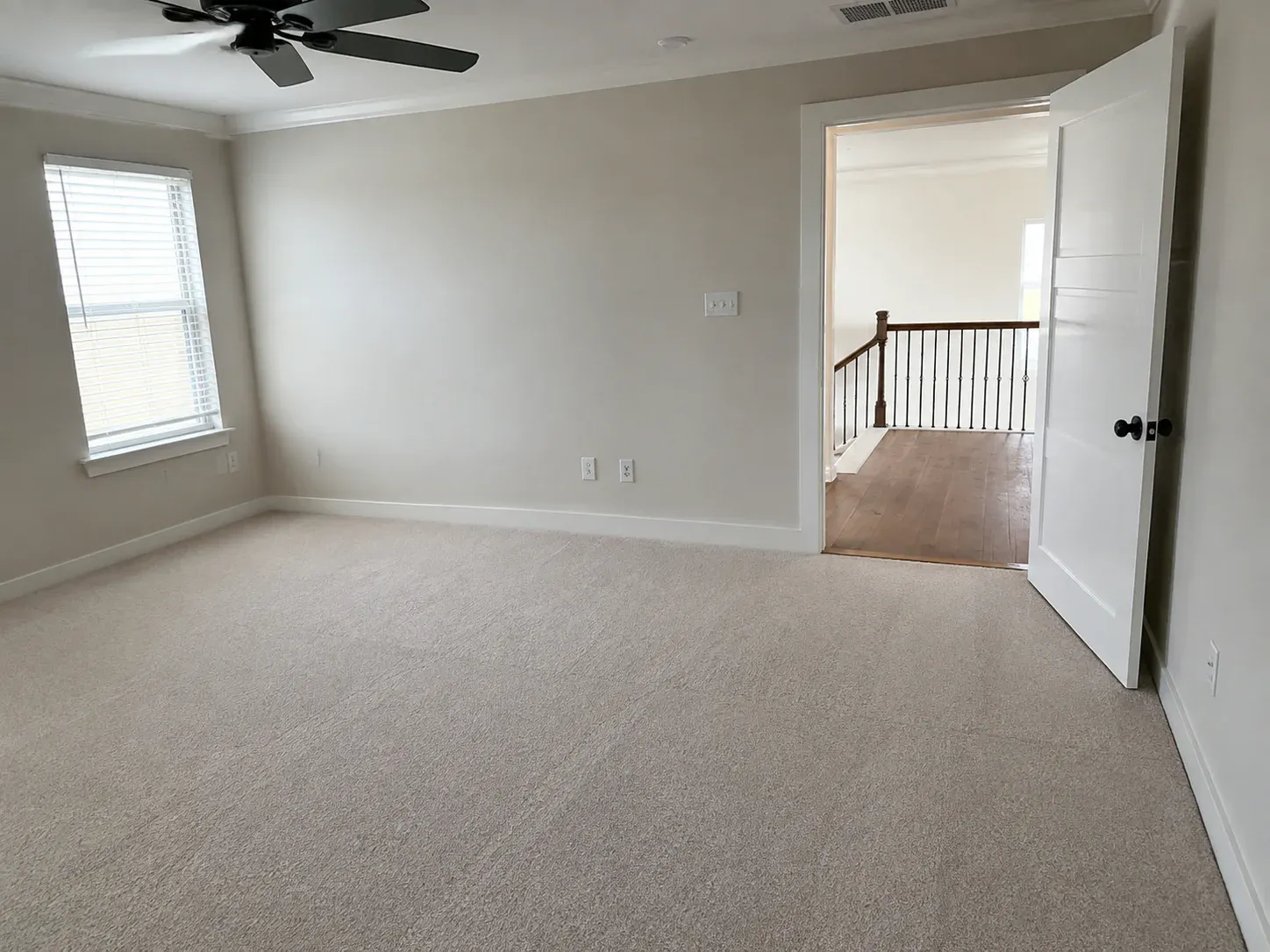 Selection concept showing a finished neutral carpeted bedroom transitioning to warm pecan hardwood